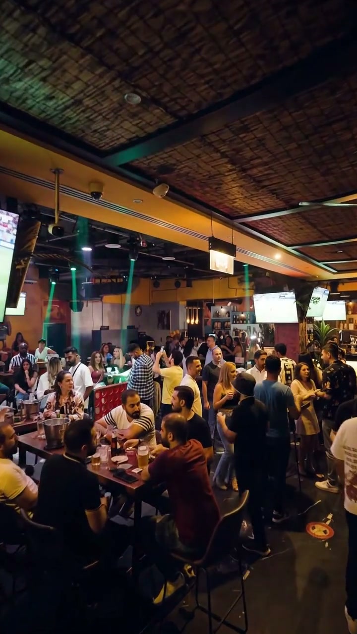 Warm, candle-lit interior of Little Havana lounge with a lively crowd