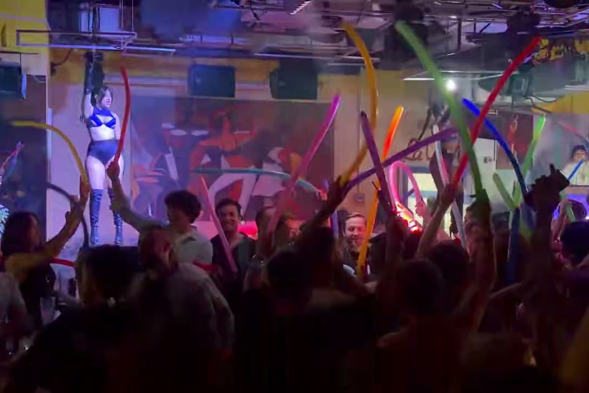Latin party atmosphere with dancers and lights